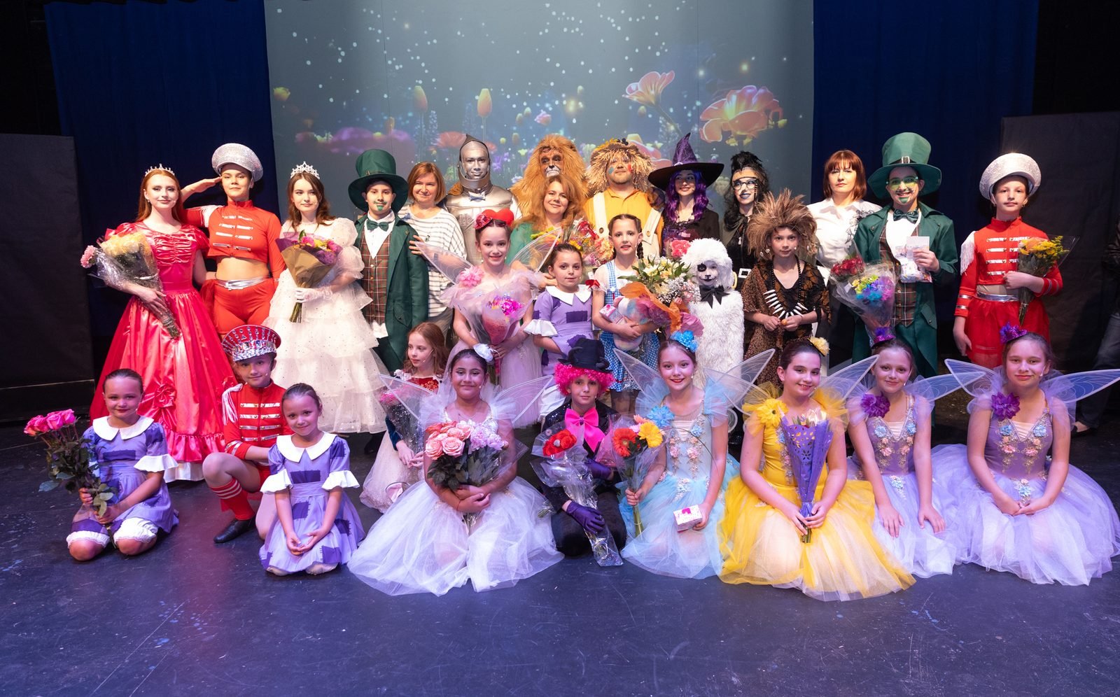 Bravo dancers and cast in costume at the curtain call
